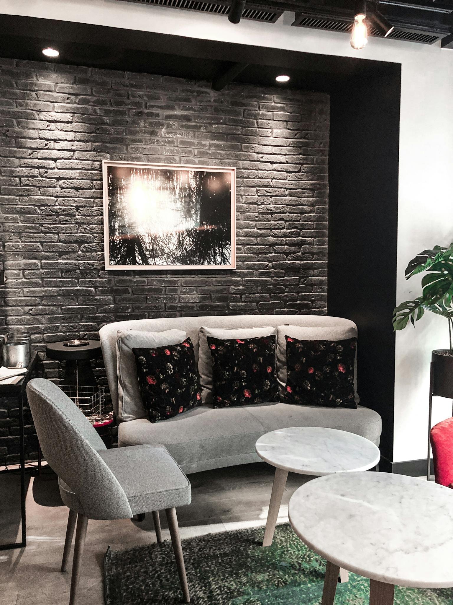 Chic modern lounge with elegant furniture, cozy lighting, and stylish brick wall decor.